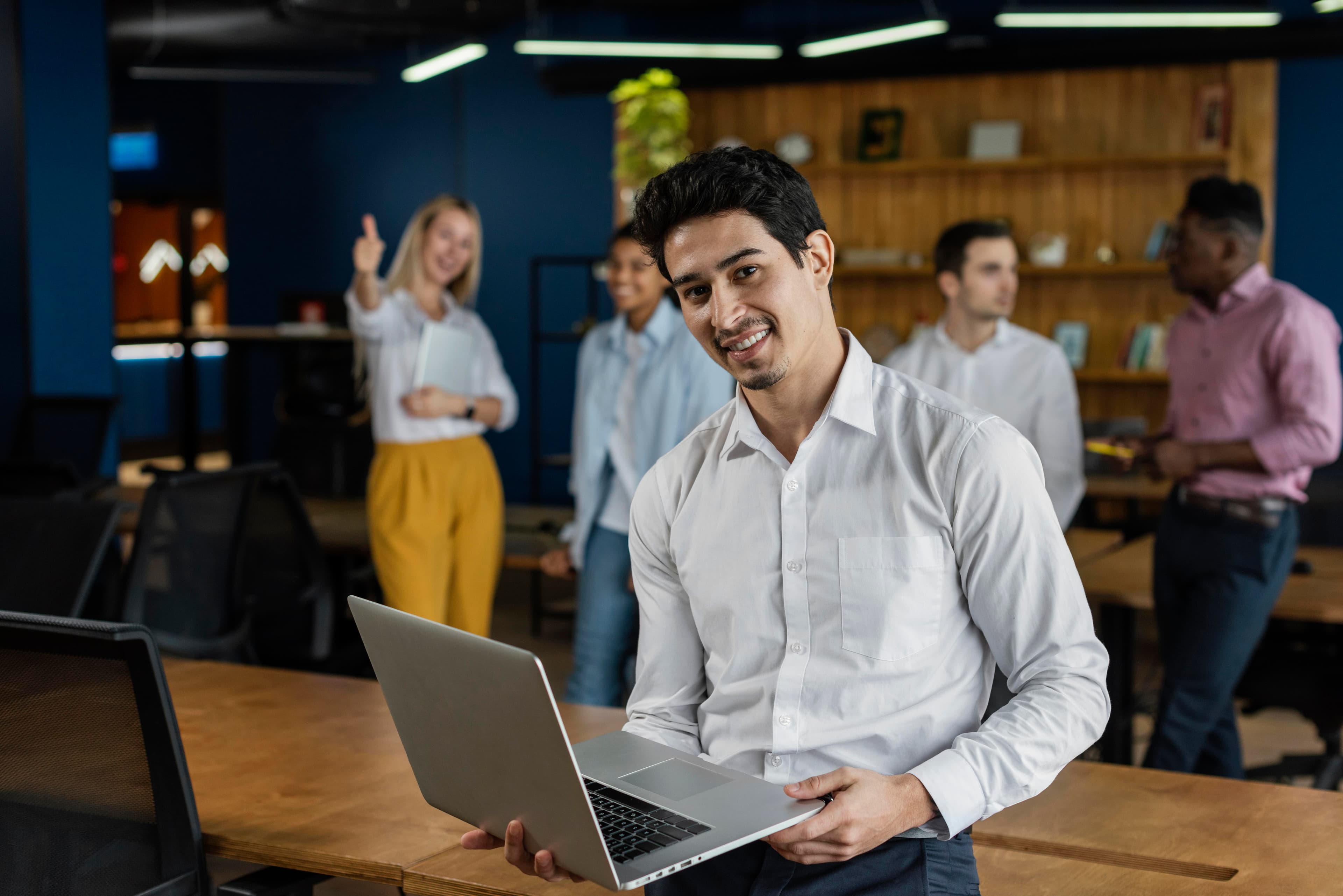 smiley-man-work-holding-laptop-posing.jpg